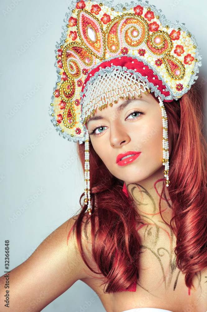Fototapeta premium Closeup portrait of pretty young woman with red hairs