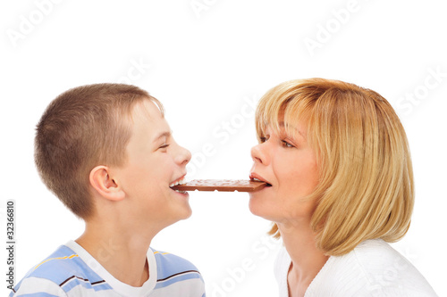 Portrait of happy european family of son and his mother eating c