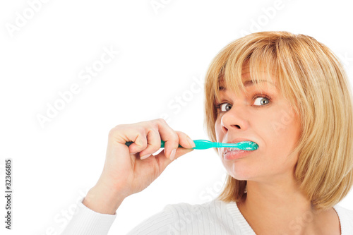Detail portrait of a happy mature woman brushing her teeth