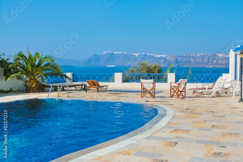 Blue swimming pool in Fira on island of Santorini  Greece.