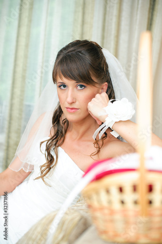 pensive bride in a white dress looking at camera