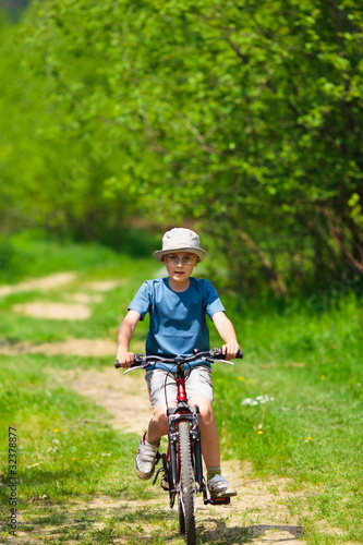 Boy with hat riding a bicycle