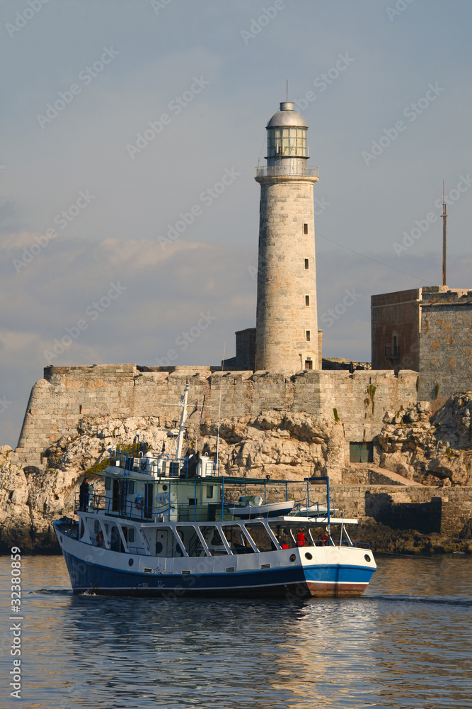 Morro lighthouse and Barge leaving Havana bay