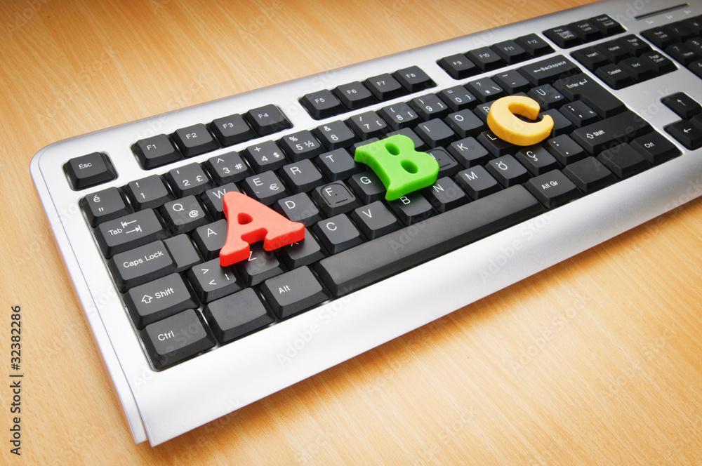 Early education concept with keyboard and letters Early education concept with keyboard and letters