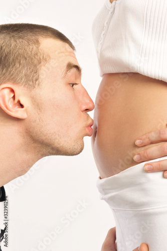 Husband kissing his pregnant wife belly