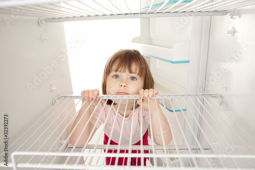 Girl looking in empty fridge