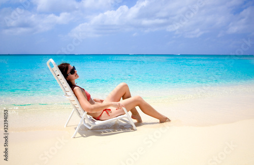 woman sitting in a beach chair in the caribbean