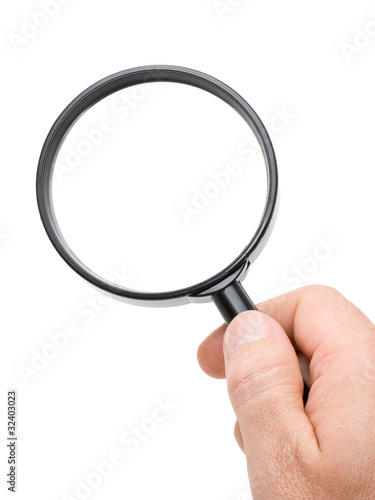 Hand holding magnifying glass