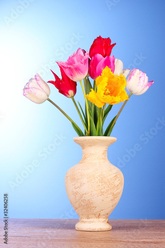 Fototapeta Naklejka Na Ścianę i Meble -  Tulips in vase on blue background