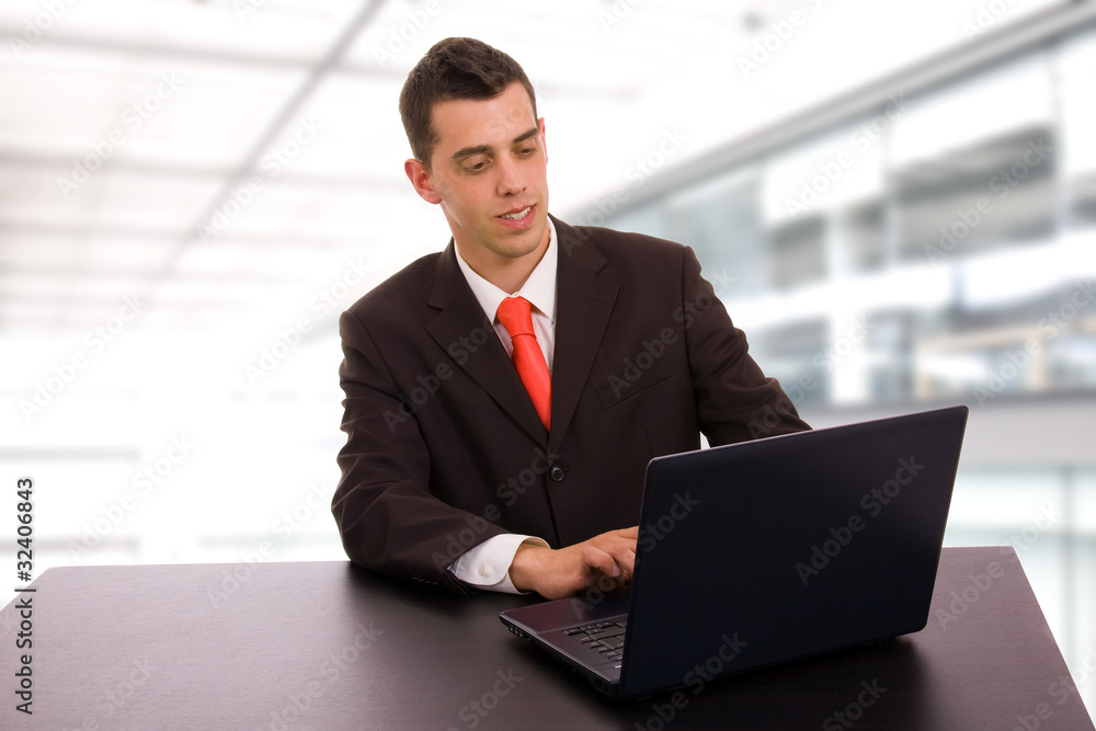young business man working with is laptop at the office young business man working with is laptop at the office