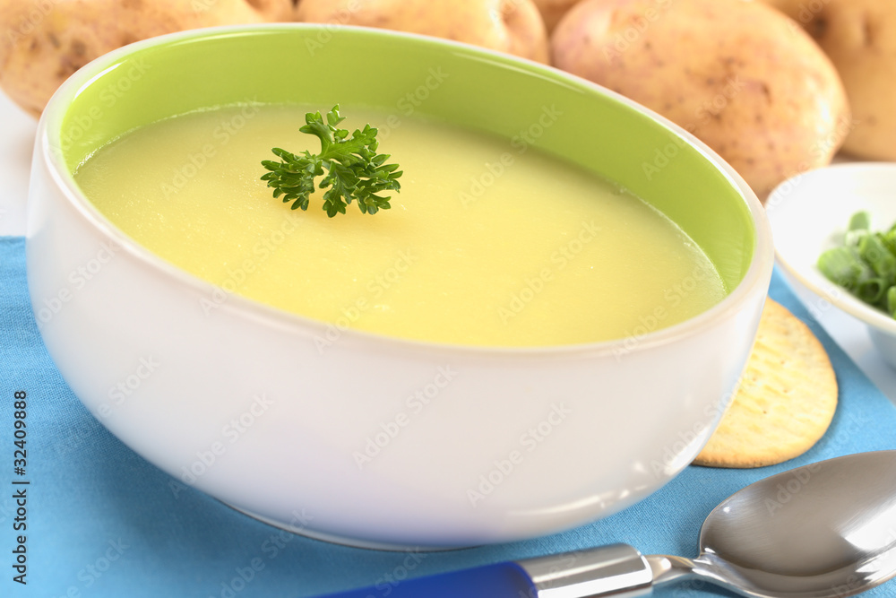 Fresh potato cream soup garnished with a parsley leaf Fresh potato cream soup garnished with a parsley leaf