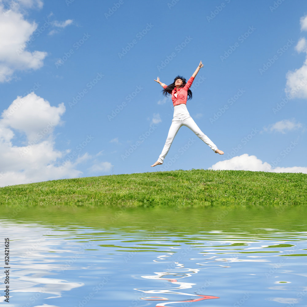 pretty young woman jumping on green grass pretty young woman jumping on green grass