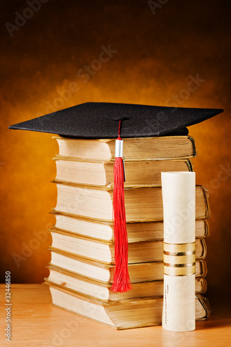 Graduation cap, books and diploma