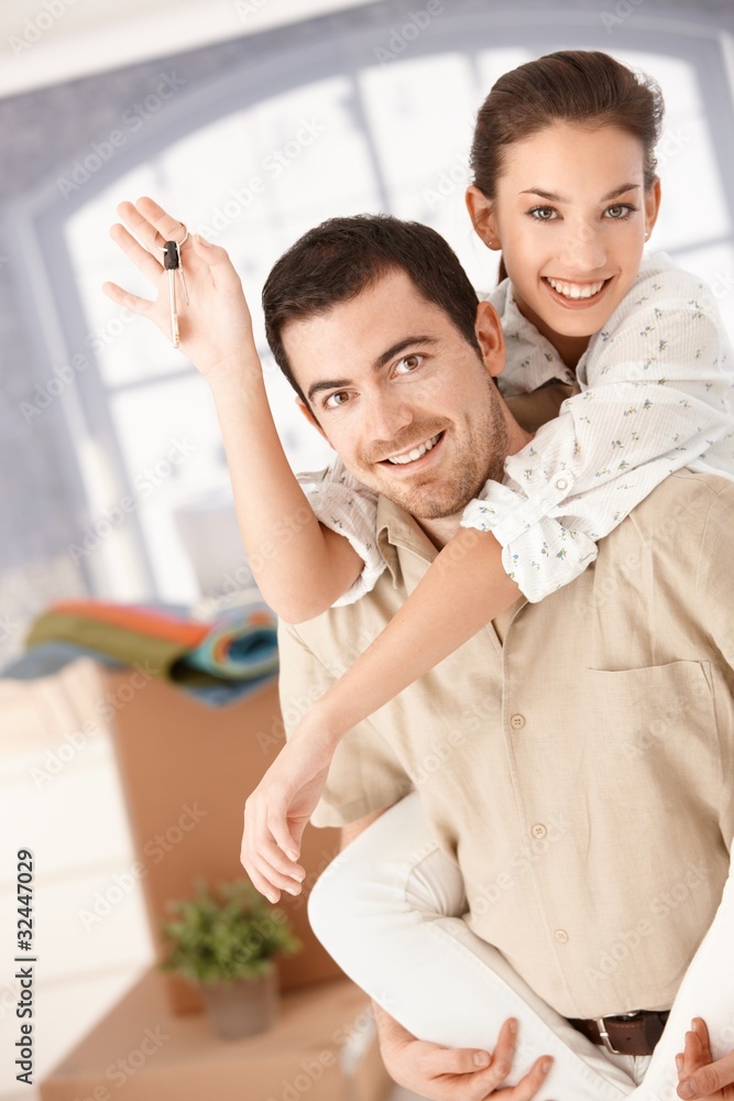 Happy couple moving house smiling Happy couple moving house smiling