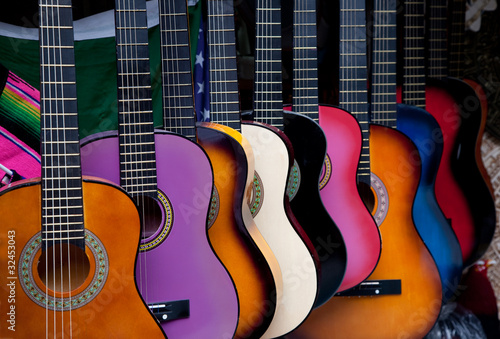 Obraz na plátně Row of multi-colored Mexican guitars