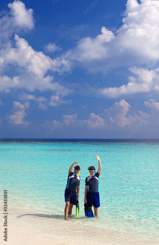 Two men in the sea with the equipment for a snorkeling