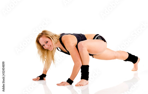 Young attractive Caucasian fitness woman doing gymnastics