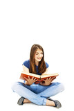Attractive teenage girl reading a book