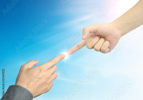 woman hand touch businessman hand on blue sky background