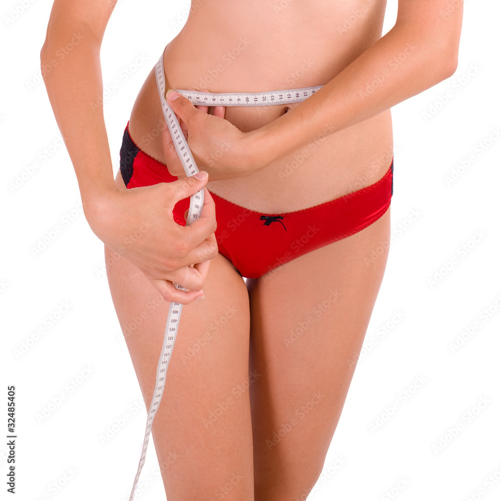 Young Caucasian woman measuring her slim body