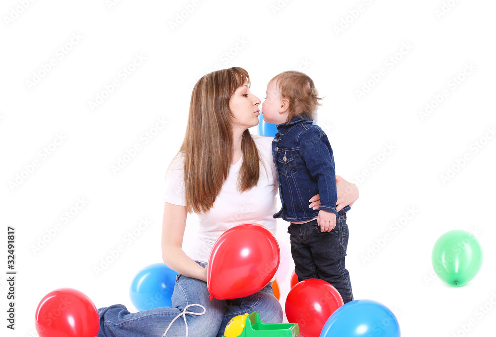 Happy family. Mum kisses the small daughter Happy family. Mum kisses the small daughter