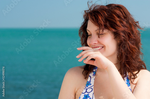 Shy Smiling Woman on a Beach
