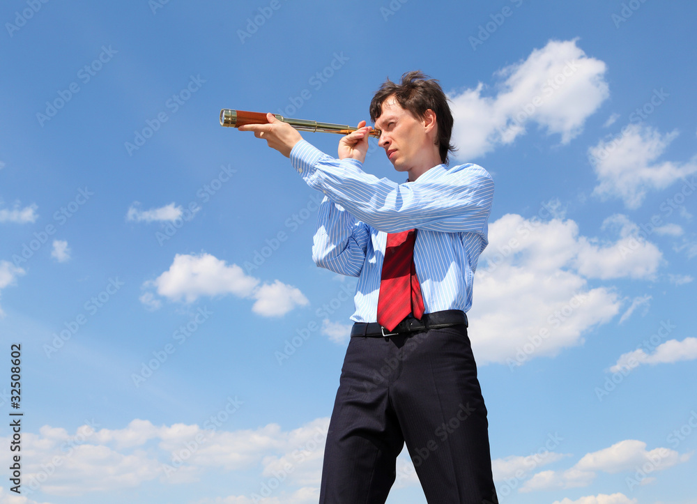 young business man looks through a telescope young business man looks through a telescope