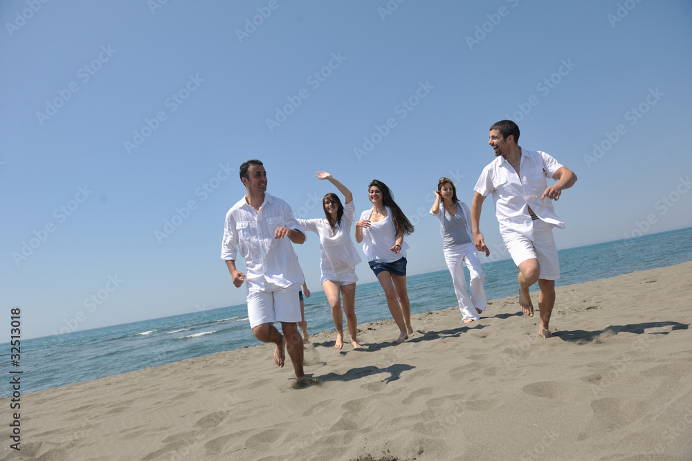 happy people group have fun and running on beach