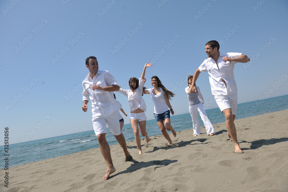 happy people group have fun and running on beach