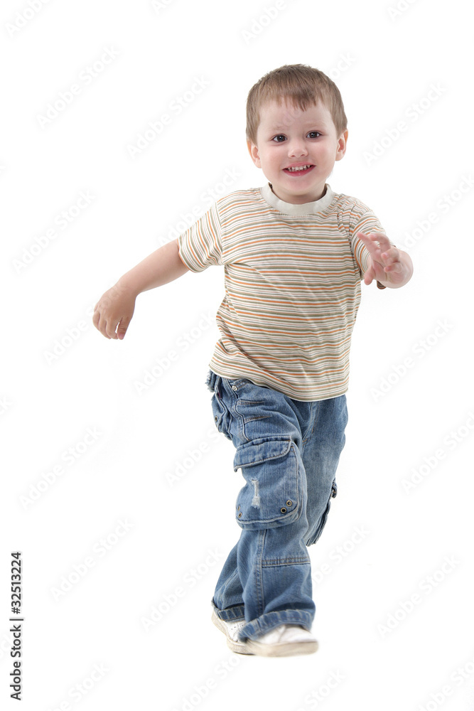 young boy running over white
