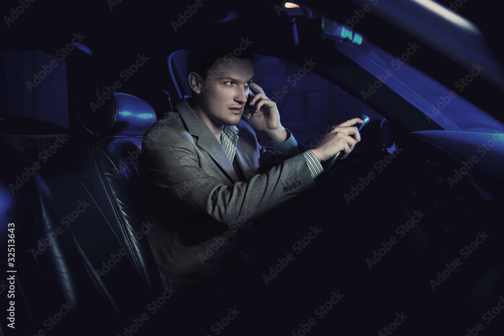 Fototapeta premium Elegant man driving and talking over cellphone