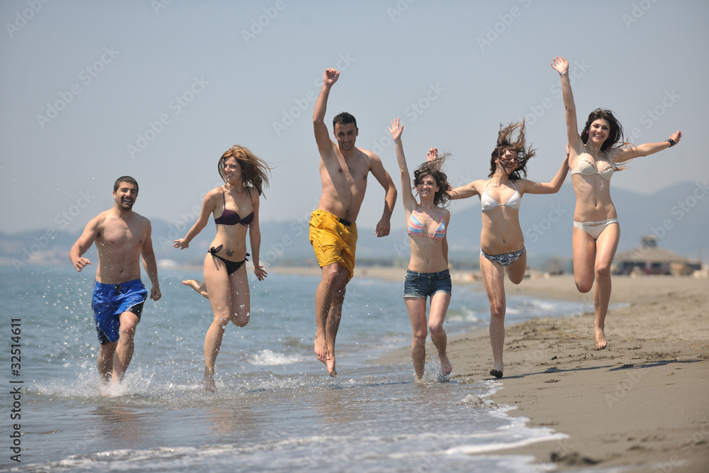 happy people group have fun and running on beach happy people group have fun and running on beach