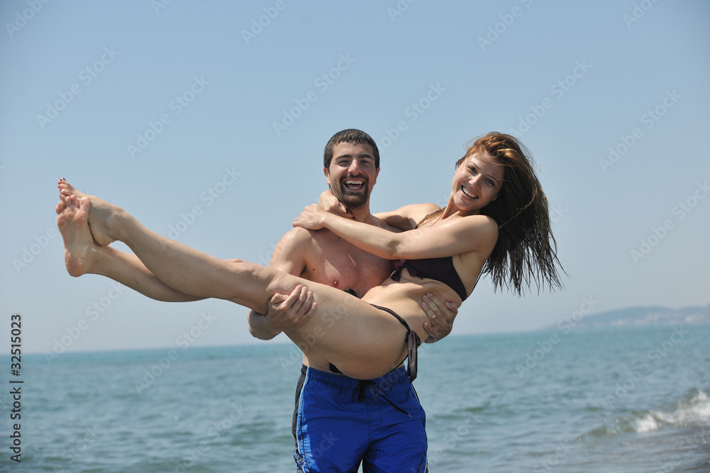 happy young couple have fun on beach happy young couple have fun on beach