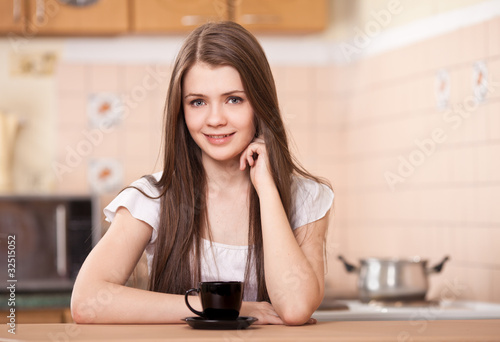 beautiful happy young woman drinking coffee at home