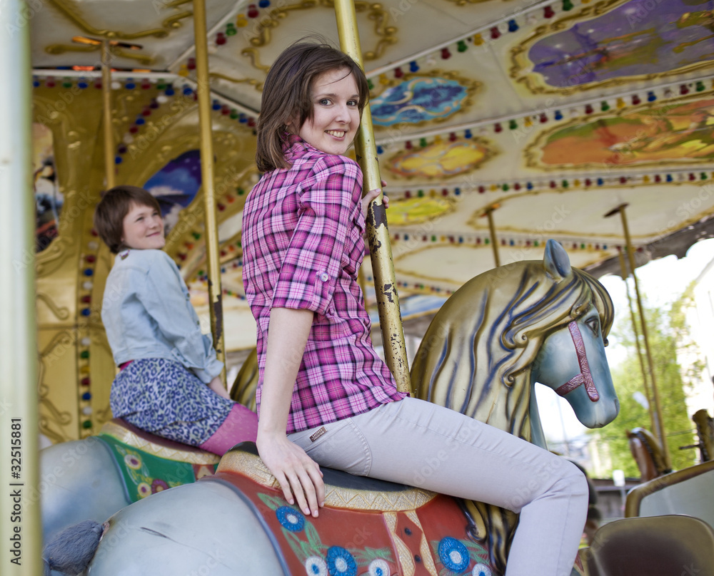 Happy friends on the carousel