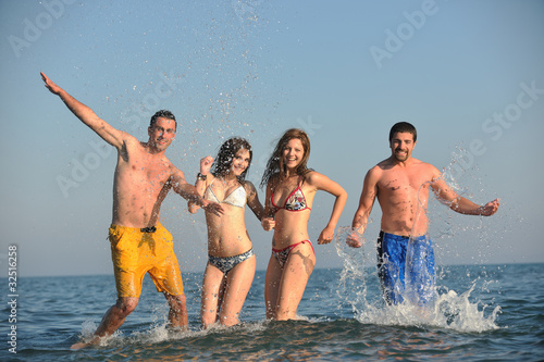 happy people group have fun and running on beach