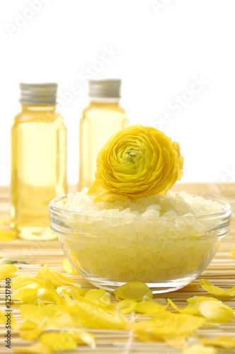 bowl of bath salt and massage oil with dahlia petals