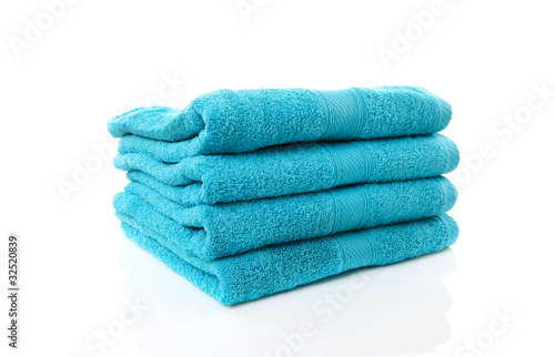 Pile of blue towels over white background