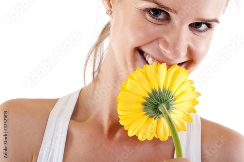 woman smelling a yellow flower