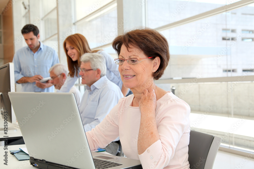 Senior woman attending business training Senior woman attending business training
