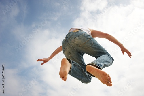 Man jumping against blue sky