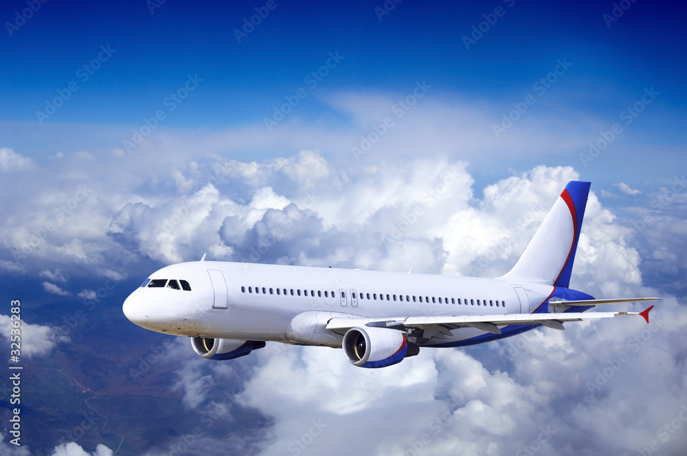 Obraz premium Airplane at fly on the sky with clouds