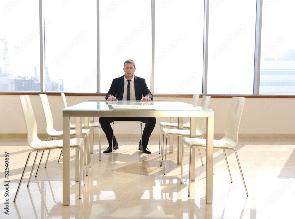 young business man alone in conference room young business man alone in conference room