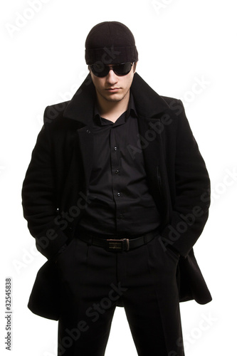 confidence man in black coat and sunglasses