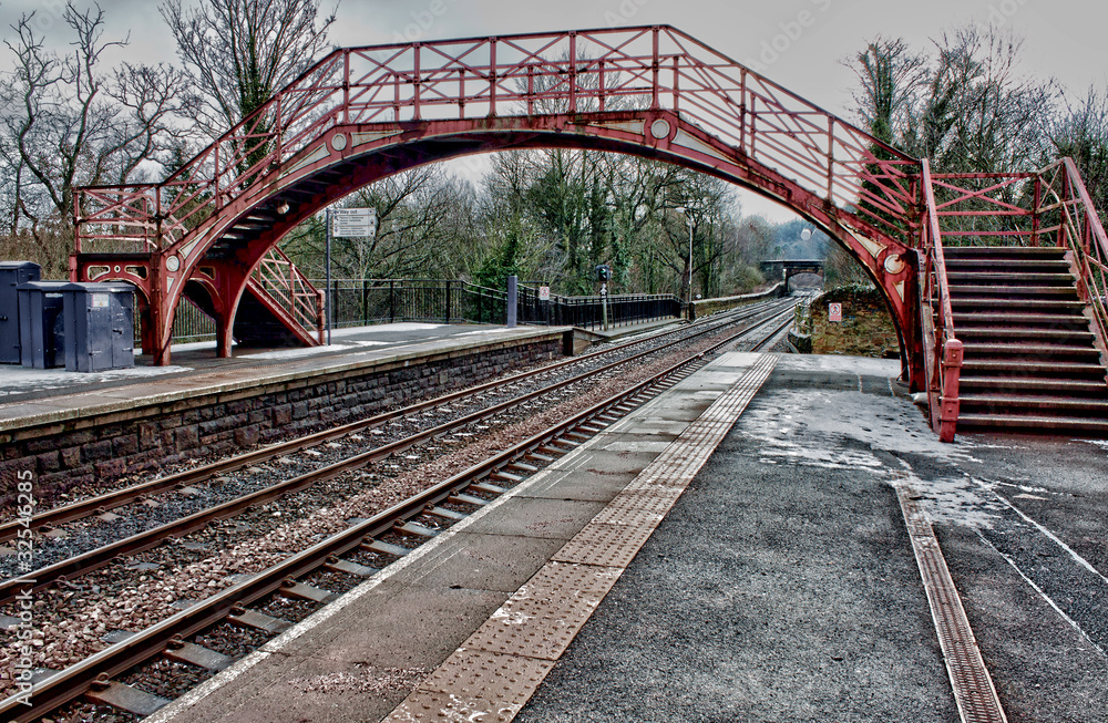 Fototapeta premium Old English railway platform bridge and lines