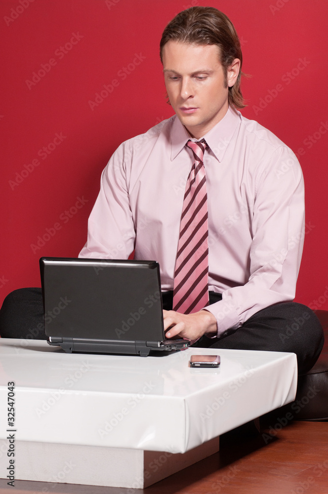 Concentrated businessman using a laptop Concentrated businessman using a laptop