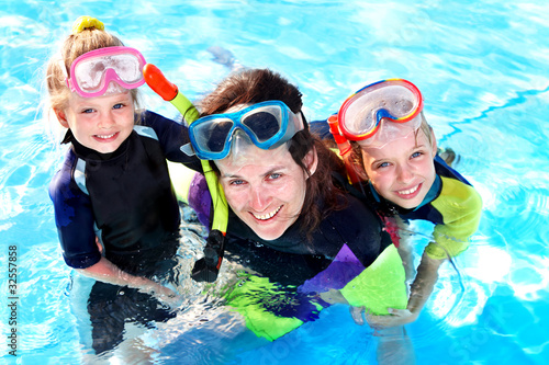 Children in swimming pool learning snorkeling.