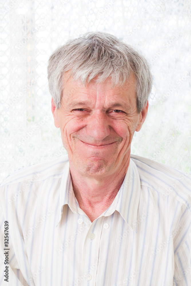 Portrait of a handsome older man looking at camera and smiling Portrait of a handsome older man looking at camera and smiling