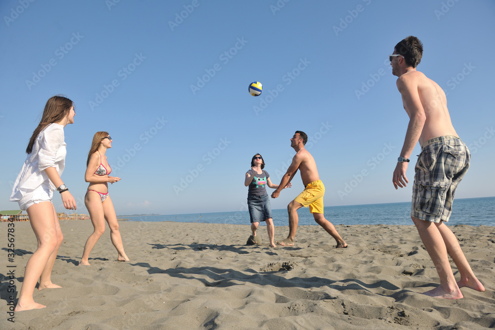 young people group have fun and play beach volleyball young people group have fun and play beach volleyball