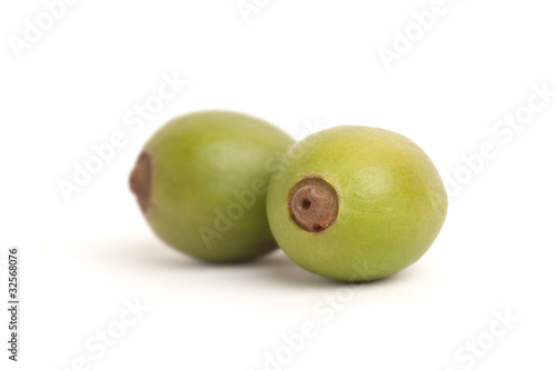 Unripe coffee fruits isolated on a white background